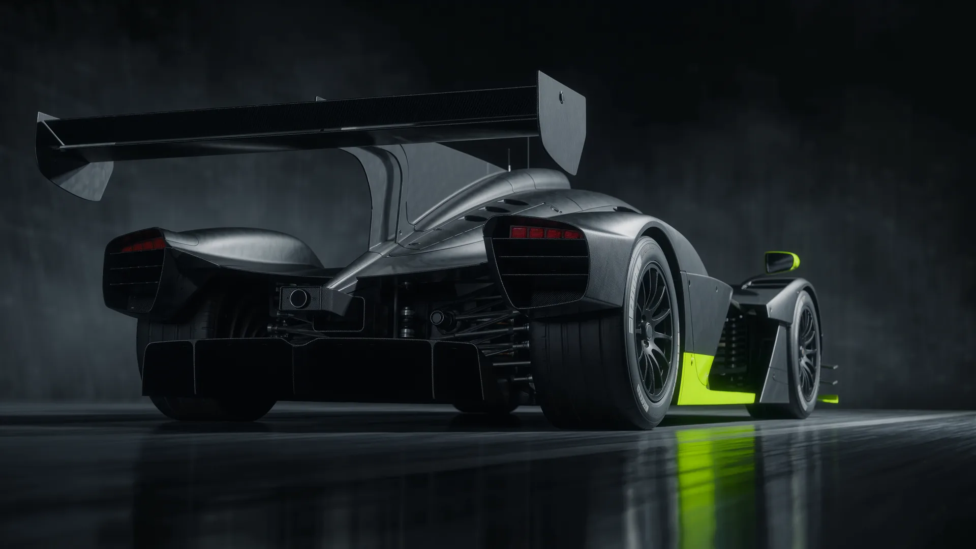Racing car braking heavily with its rear wing raised into air brake position