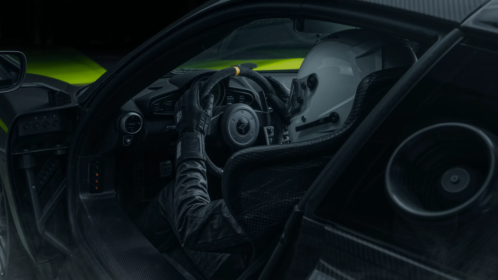 Racing driver at the wheel of a performance car concentrating through a fast corner