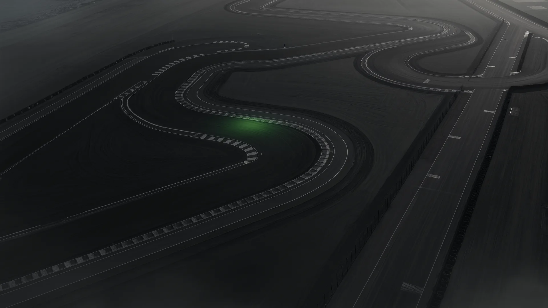 Aerial view of a permanent racing circuit showing a mix of fast and slow corners