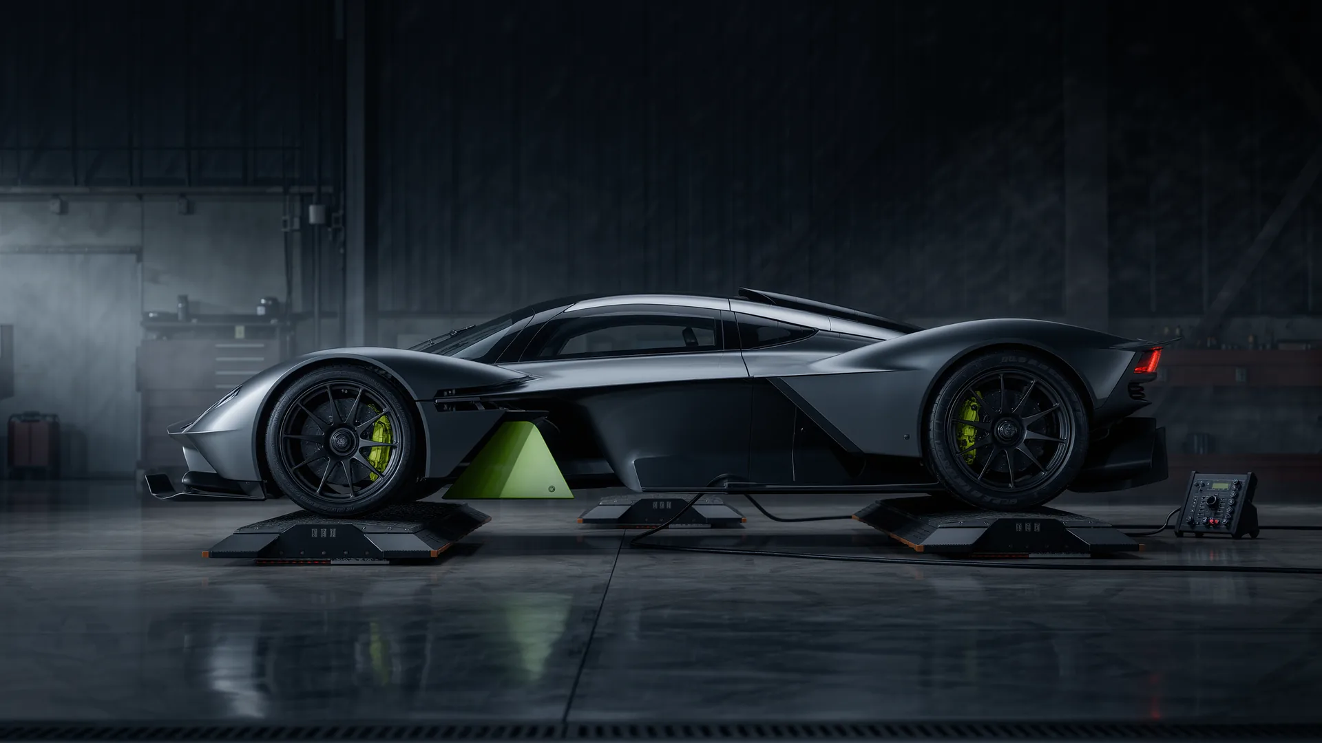 Performance car positioned on corner weight scales in a workshop
