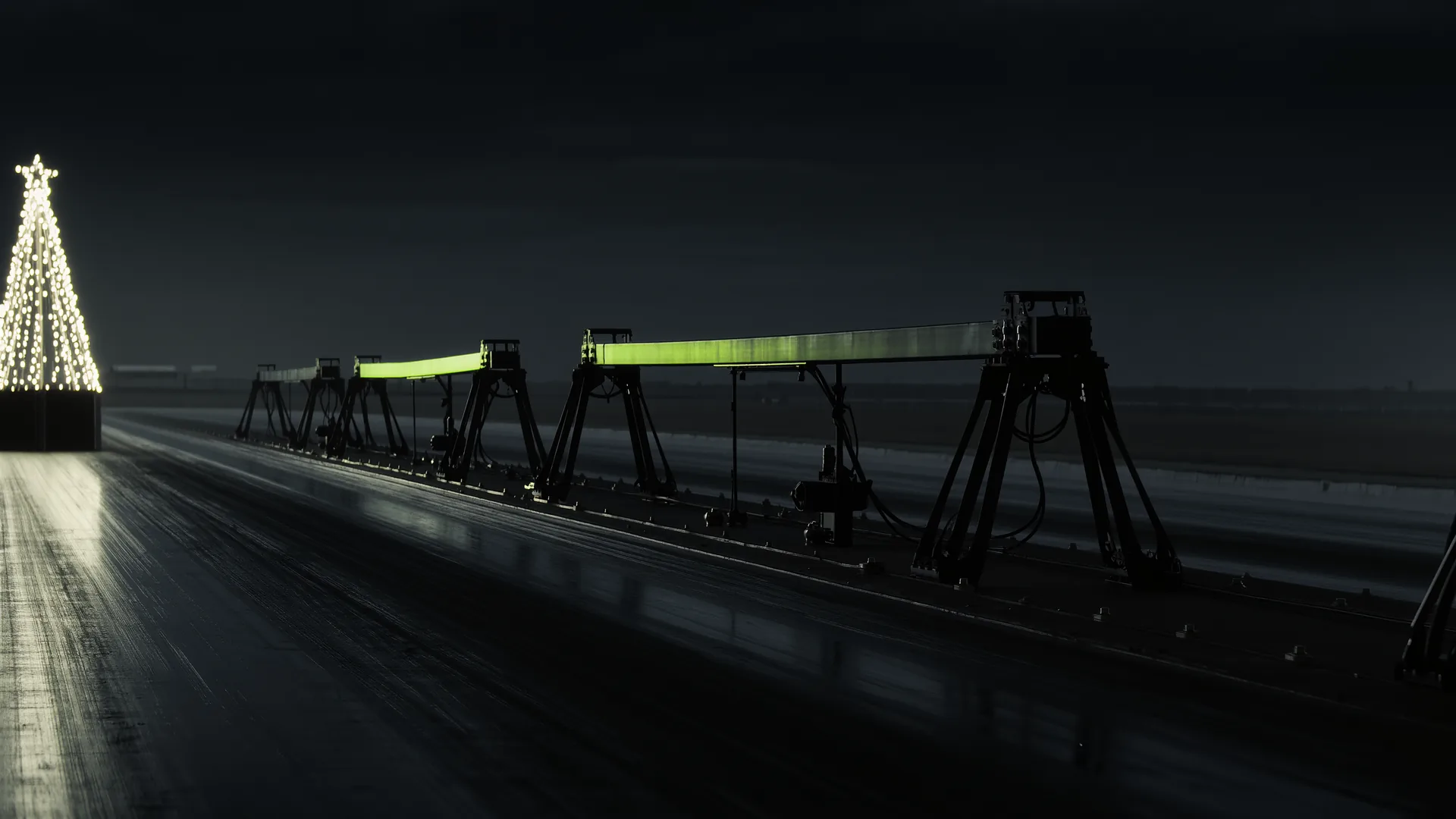 Timing beam and staging lights at the start line of a drag strip at dusk