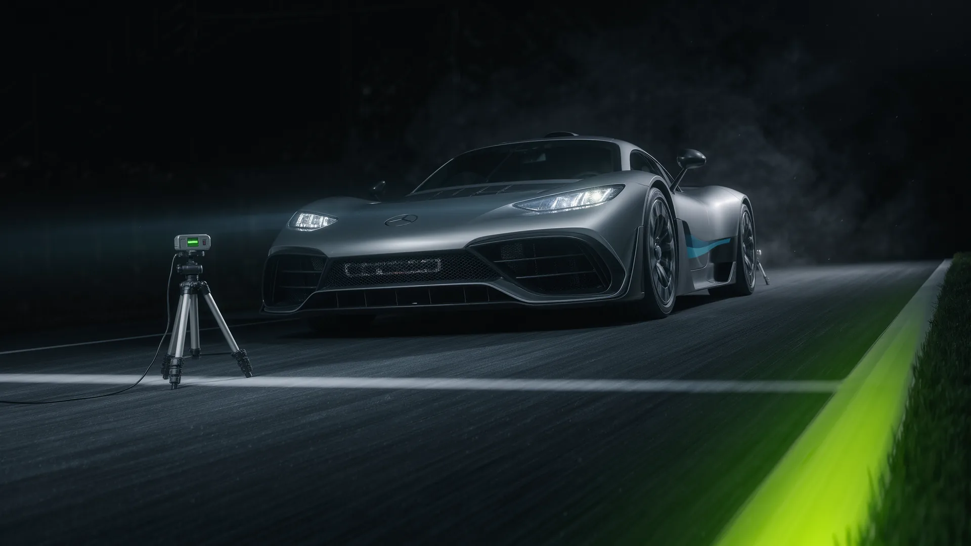 Performance car launching from a standing start with timing equipment beside the strip